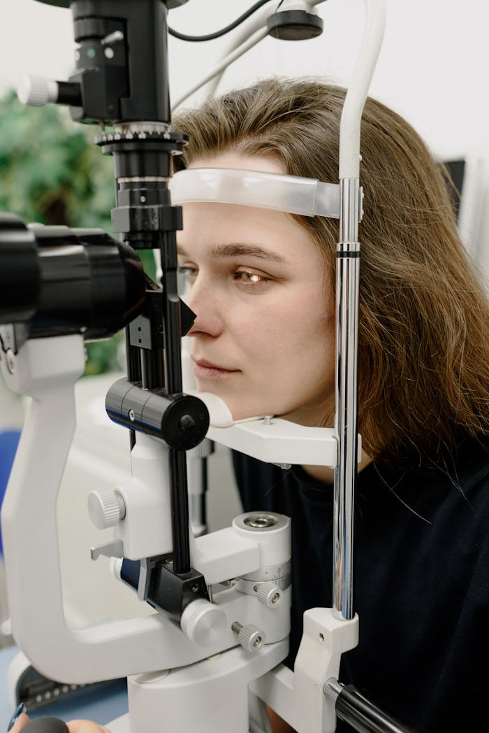 Close-up of a woman during an eye examination using a slit lamp in a modern clinic.